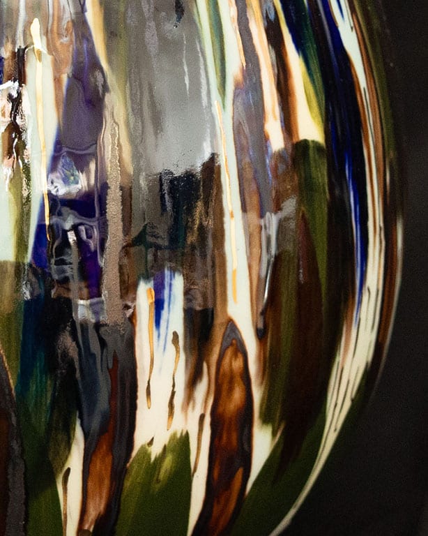 Close up of - Porcelain object by Pia Andersen, inspired by water, light and reflections, with layered underglazes, oxides and details in 14-carat gold.