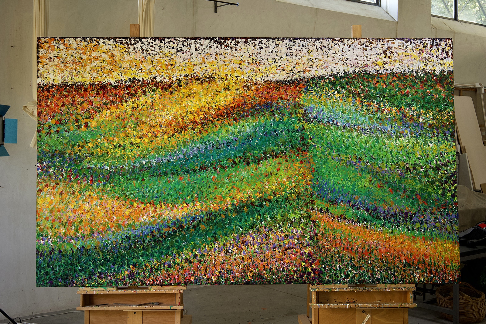 Gredos by Pia Andersen,close up with luminous greens, warm yellows, oranges and richly layered surfaces. Here in the studio.
